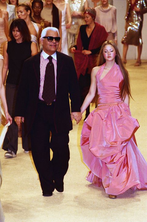 german fashion designer karl lagerfeld and a fashion model wearing a women's haute couture pink halter and skirt designed by lagerfeld for french fashion house chanel at the 1999 chanel spring and summer haute couture fashion show in january 1999 photo by pierre vautheysygmasygma via getty images