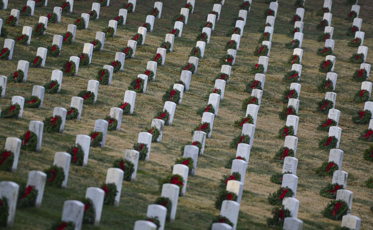 WASHINGTON, DC - DECEMBER 17: More than 50,000 anticipated volunteers placed remembrance wreaths on the nearly 245,000 headstones in Arlington National Cemetery on December 17, 2016 in Arlington, Virginia. The year 2016 marks the 25th year that wreaths have been placed in remembrance of those who have fought for the country's freedoms.