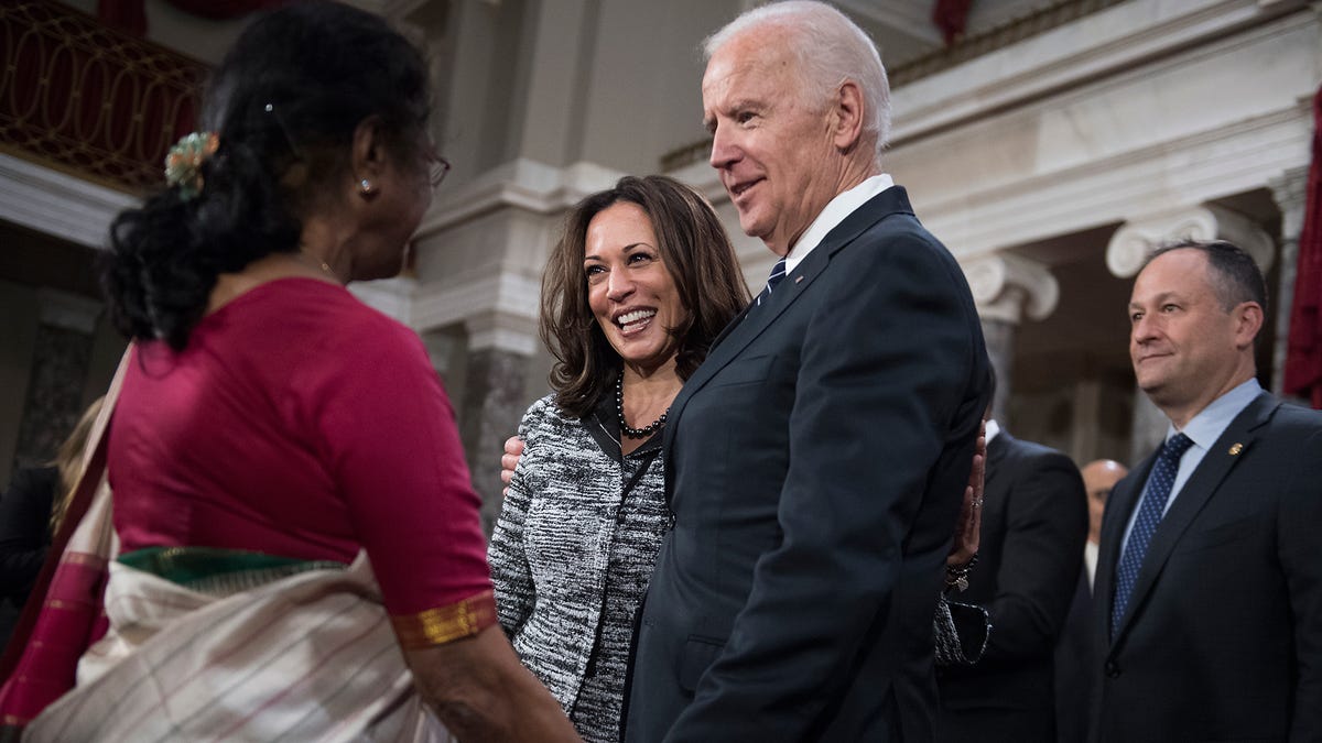 Joe Biden talks with Kamala Harris and her aunt, Dr. Sarala Gopalan, during a swearing-in ceremony in the Capitol's Old Senate Chamber, January 3, 2016.