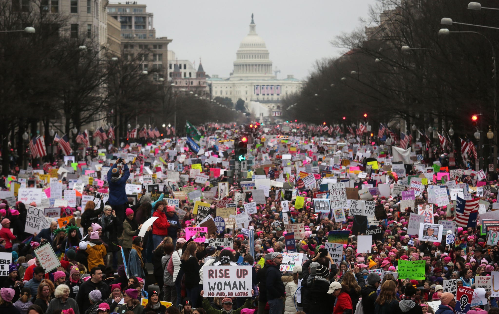 washington, dc january 21 protesters walk during the women's march on washington, with the us capitol in the background, on january 21, 2017 in washington, dc large crowds are attending the anti trump rally a day after us president donald trump was sworn in as the 45th us president photo by mario tamagetty images