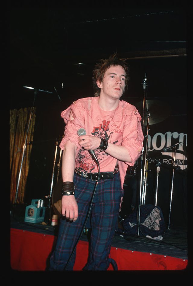 original caption  1978 sex pistols singer johnny rotten on stage performing he is shown in a 34 length shot, wearing plaid pants   photo by lynn goldsmithcorbisvcg via getty images