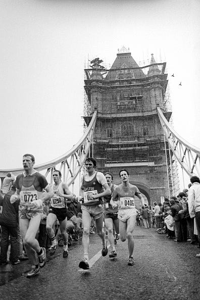 competitors cross tower bridge to reach the half way stage of the 1st london marathon  photo by chris colepa images via getty images