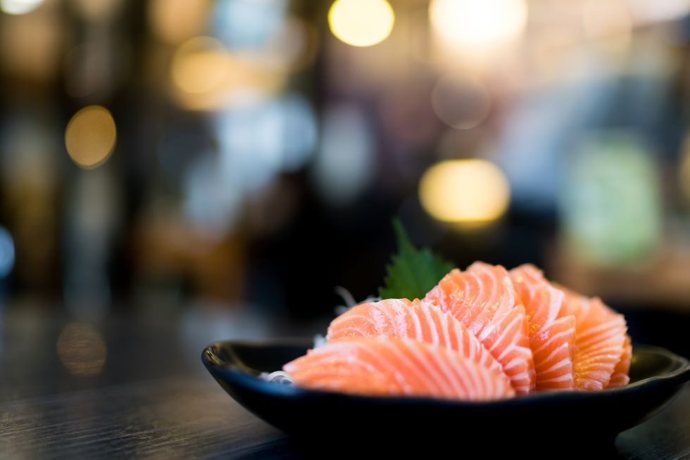 Sliced salmon sashimi served on wooden table