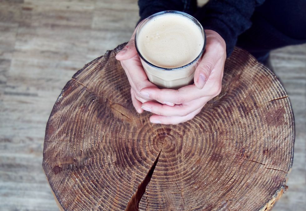 a cozy cup of coffee on a tree stump coffee table