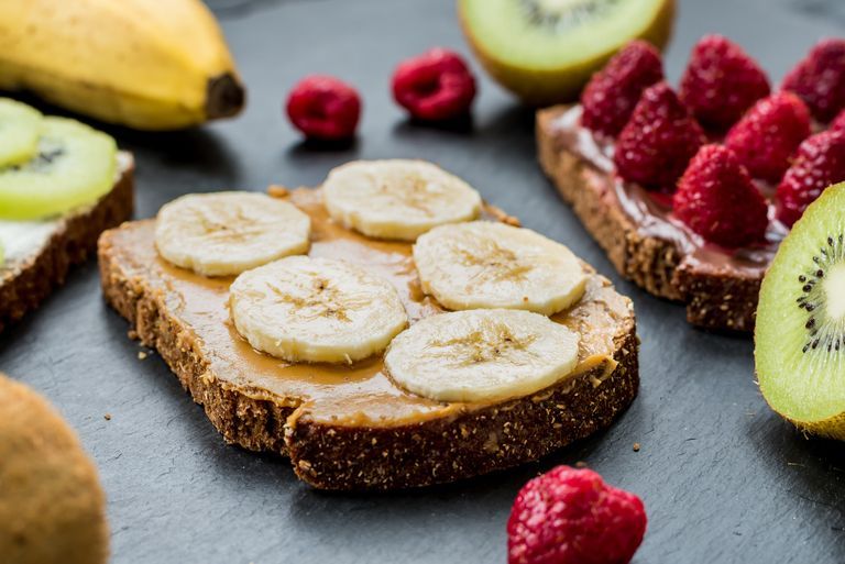 weight loss breakfast sweet delicious gluten free toasts with ripe raspberries, bananas and kiwi
