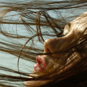 caucasian woman with hair blowing in wind