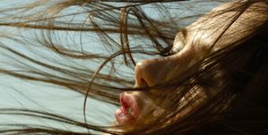 caucasian woman with hair blowing in wind