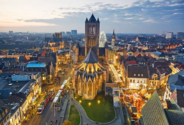 aerial view of the medieval st nicholas church and skyline of ghent with christmas markets at dusk