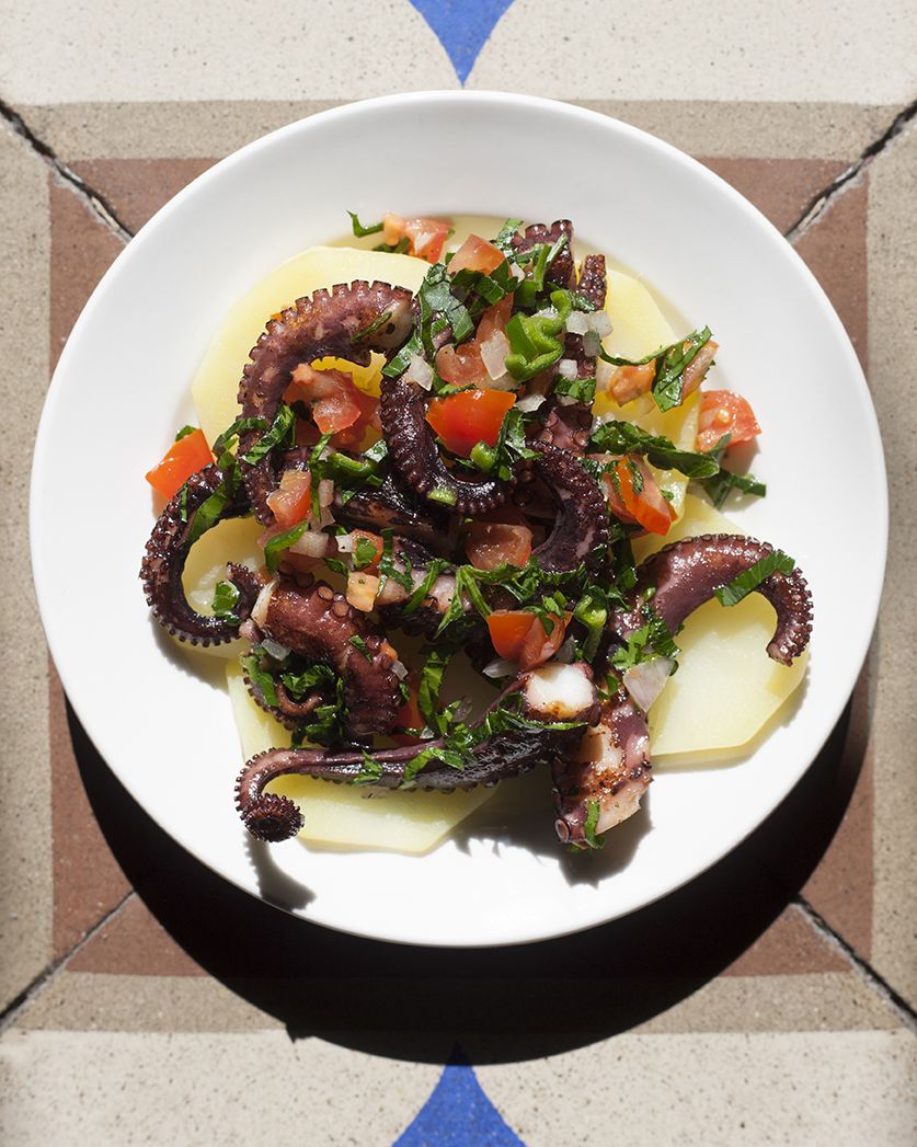 Octopus Salad with tomatos Parsley on potatos.