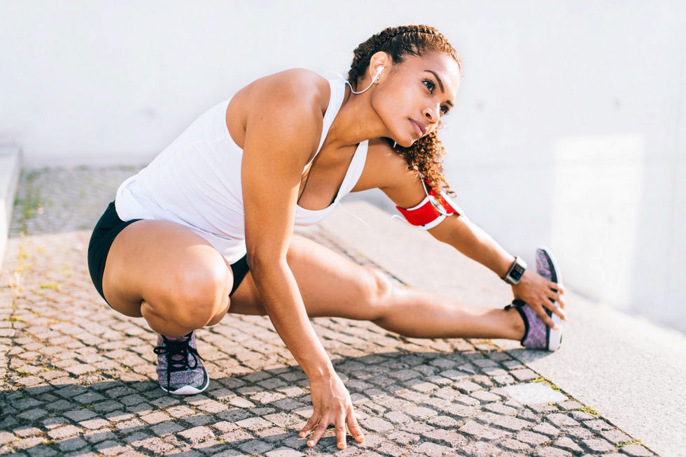 woman doing stretching after running