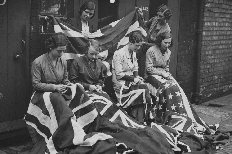 original caption scenes of great activity are being enacted at leeds and hull where factory girls are making vast quantities of union jacks, royal standards, royal ensigns etc in preparation for the forthcoming coronation of king edward viii photo shows scenes at the works of a hull flagmaker where feverish activity reigns manchester 4536 ahs21 photo by © hulton deutsch collectioncorbiscorbis via getty images