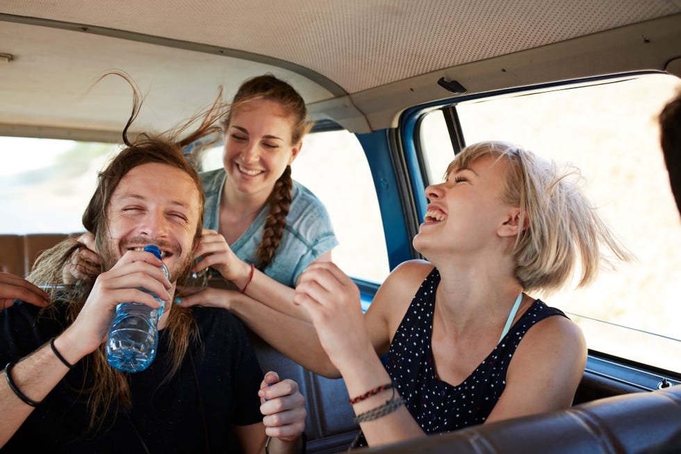 good friends on a road trip in big old car