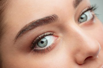 the beautiful female face. the perfect and clean skin of face on gray