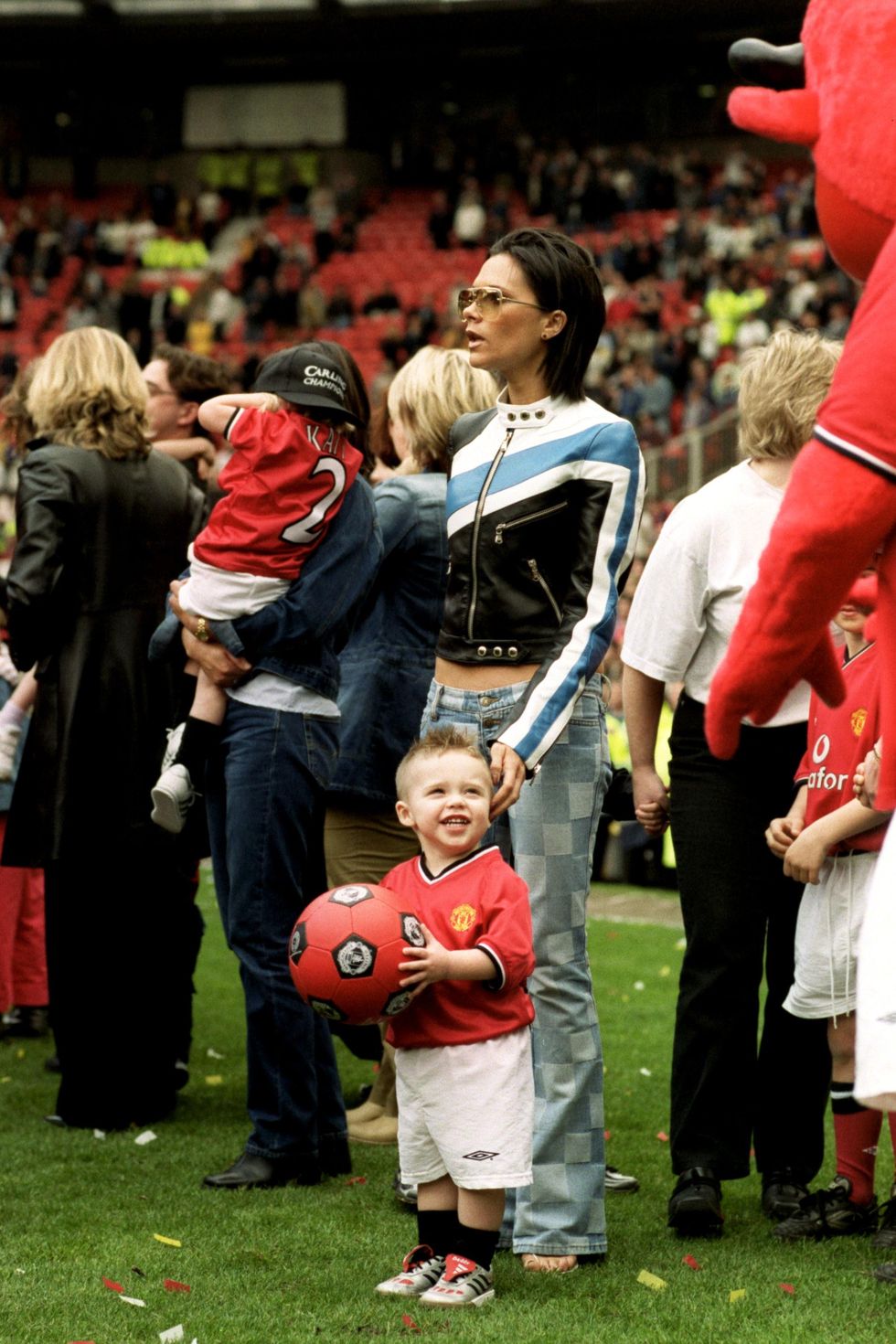 victoria beckham posh spice with son brooklyn watch the manchester united team parade the premiership trophy photo by neal simpsonempics via getty images