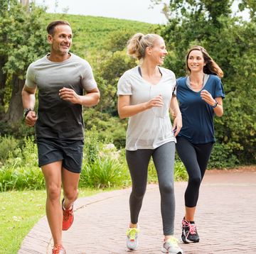 healthy group of people jogging on track in park happy couple enjoying friend time at jogging park while running mature friends running together outdoor
