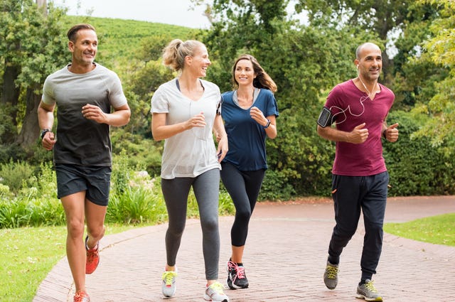 healthy group of people jogging on track in park happy couple enjoying friend time at jogging park while running mature friends running together outdoor