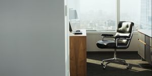 bright corner office space with desk and chairs