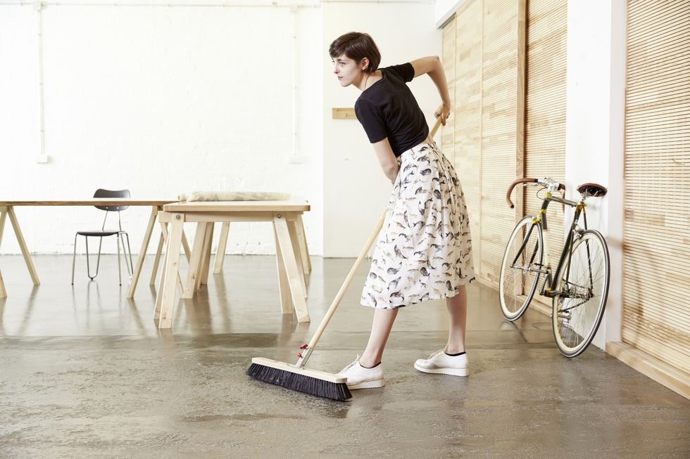 woman sweeping in a studio