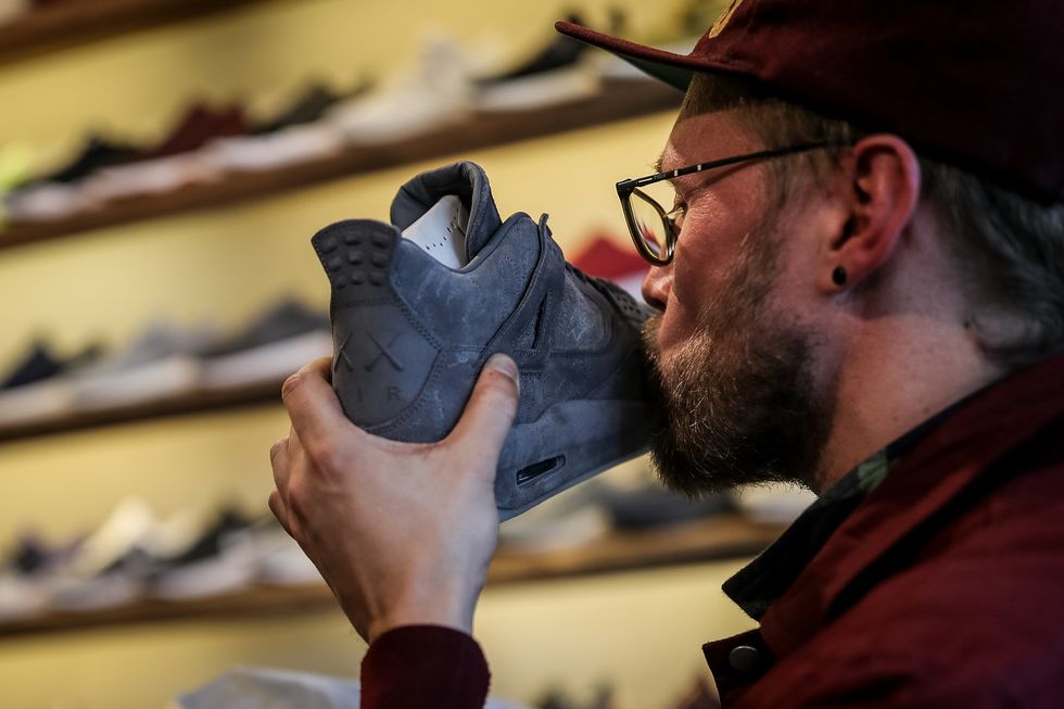 berlin, germany   march 31 new kaws x air jordan iv sneakers buyer kisses his shoe during the sale at overkill sneakers store on march 31, 2017 in berlin, germany several dozen die hard sneakers fans have taken five days out of their lives to put their names on a list and maintain their presence in order to buy the limited production shoes 50 pairs went on sale on march 31 at overkill, one of only three stores in germany to sell the shoes at eur 350 a pair the shoes carry a hefty price tag, but many of the buyers will resell them, for prices they predict could reach eur 4,000 sportswear companies like adidas and nike have hired famous designers for limited production sneakers as the appetite for the shoes by sneakers fanatics has grown into a niche market over the last few years photo by maja hitijgetty images