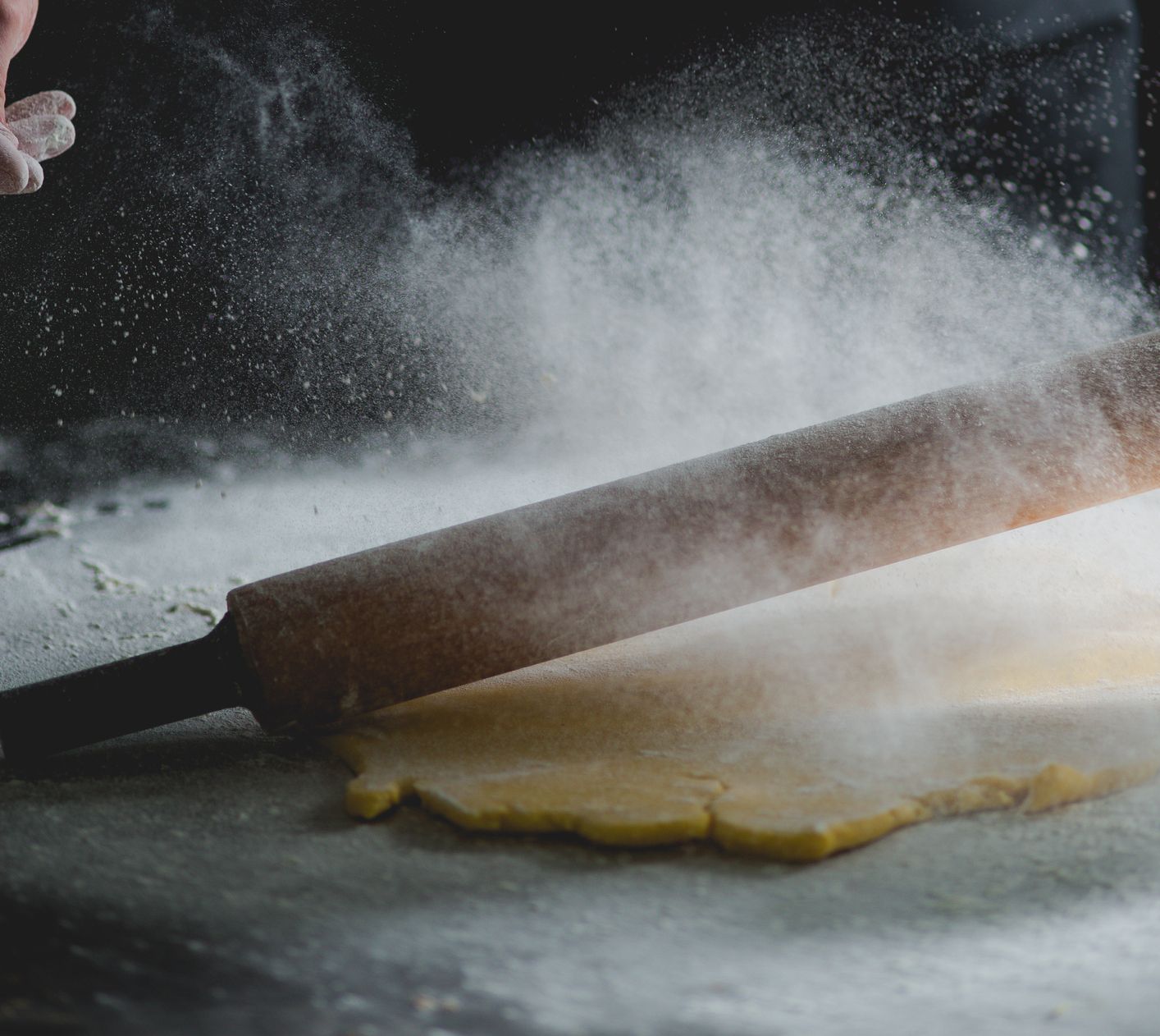 Close-Up Of Rolling Pin And Pastry Dough