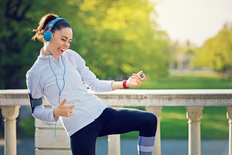 runner girl is pretend playing guitar at her favorite song