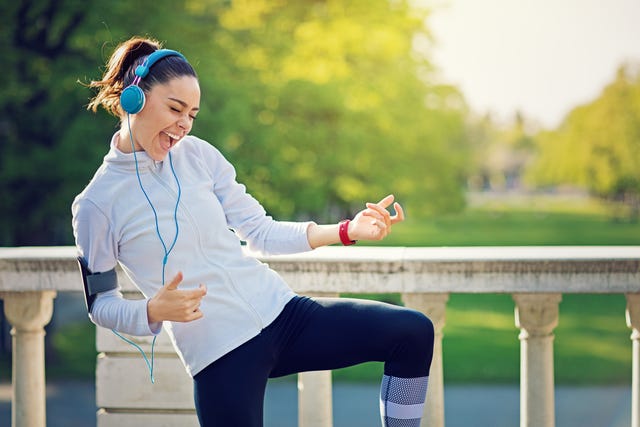 runner girl is pretend playing guitar at her favorite song