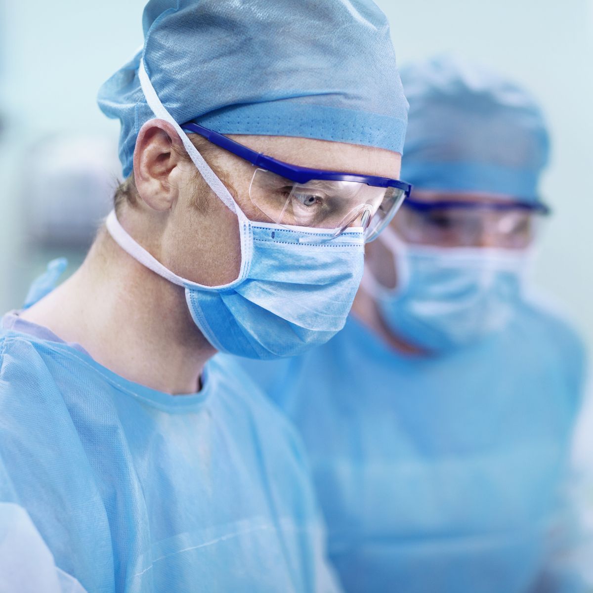 Doctor looking at surgical table in operating room