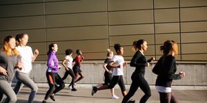 a group of people Marathon running