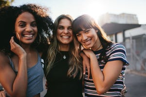 outdoor shot of three young women having fun on city street multiracial female friends enjoying a day around the city