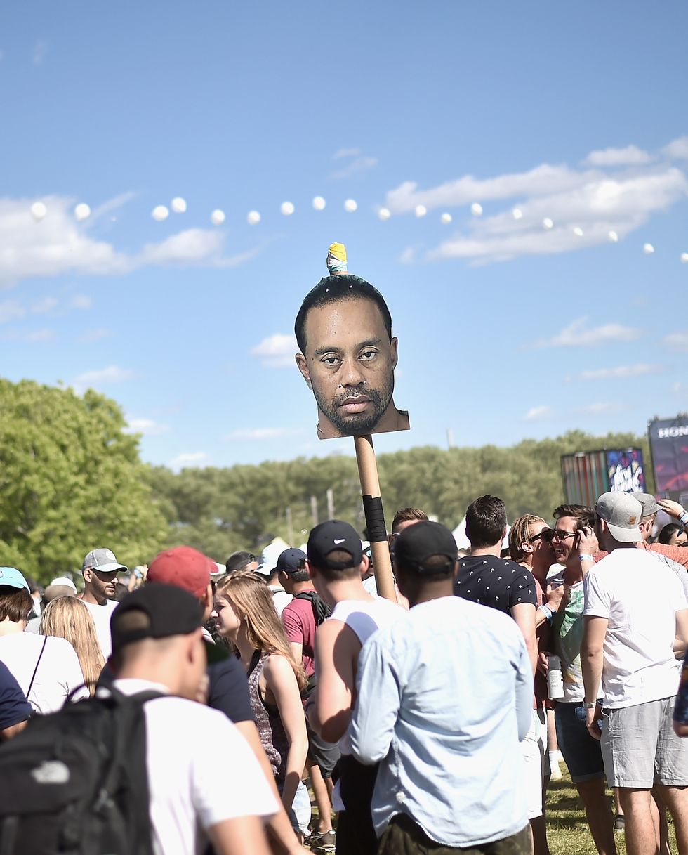 new york, ny   june 03  festivalgoers hold up a tiger woods mugshot totem during the 2017 governors ball music festival   day 2 at randalls island on june 3, 2017 in new york city  photo by steven ferdmangetty images