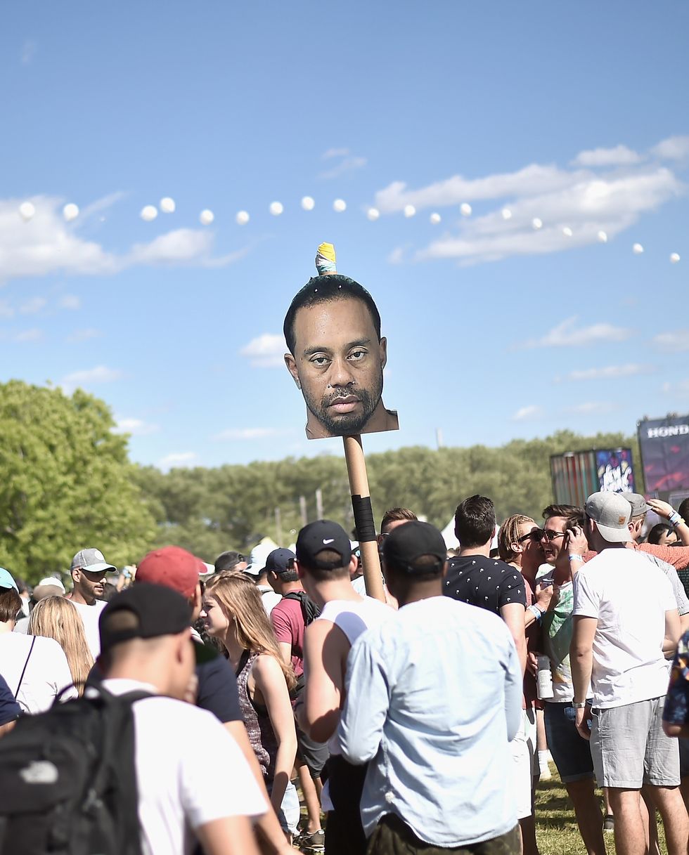 new york, ny   june 03  festivalgoers hold up a tiger woods mugshot totem during the 2017 governors ball music festival   day 2 at randalls island on june 3, 2017 in new york city  photo by steven ferdmangetty images