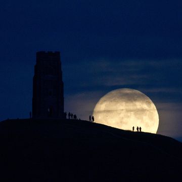 the brightest supermoon since 1948 rising behind glastonbury tor in somerset, england in november 2016 some of the people watching the moonrise from the well known landmark hilltop were silhouetted against the moon