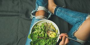 Vegetarian breakfast bowl with spinach, arugula, avocado, seeds and sprouts