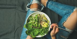 Vegetarian breakfast bowl with spinach, arugula, avocado, seeds and sprouts