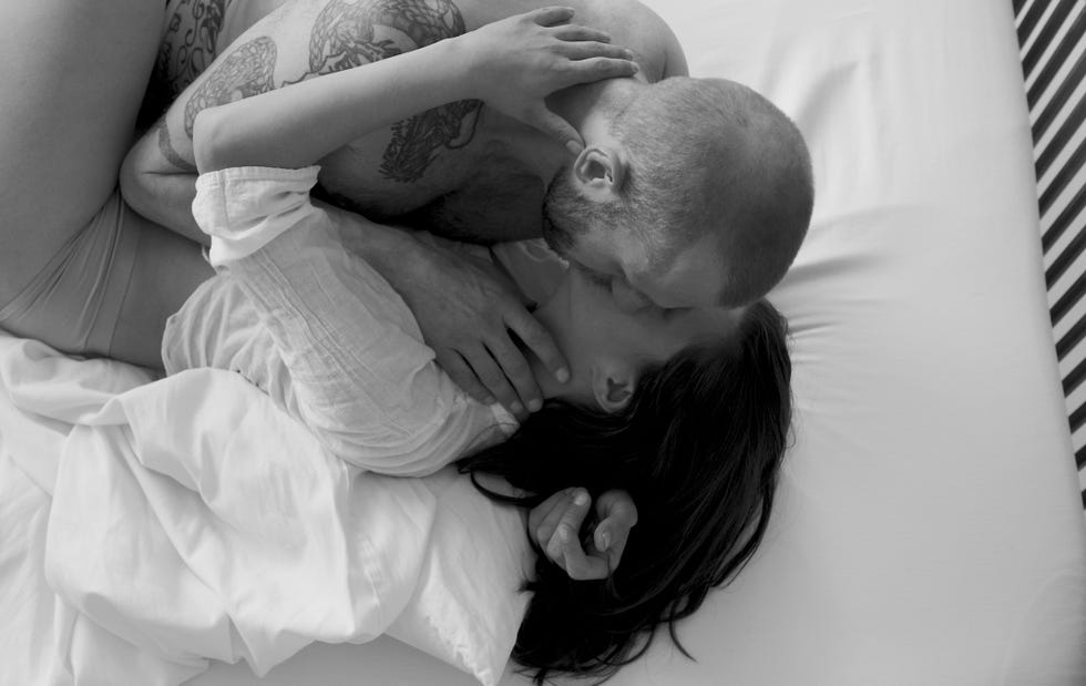 Caucasian couple kissing in bed caucasian couple kissing in bed