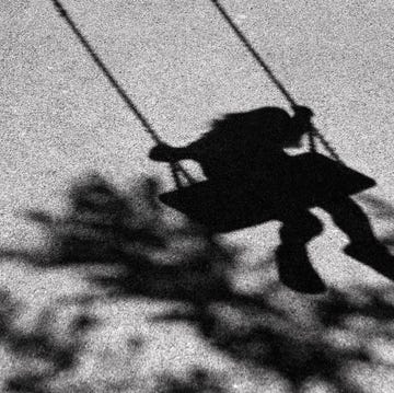 bluury shadows of little giirl on a swing and a tree branch