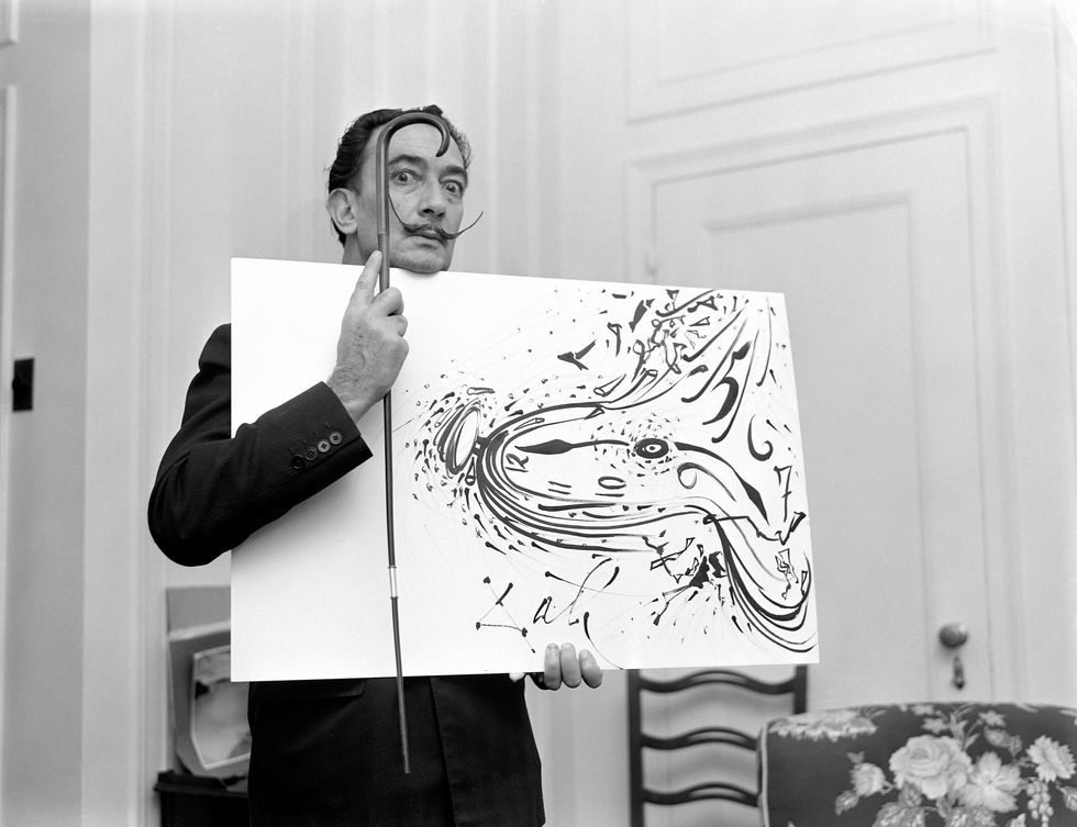 spanish surrealist painter salvador dali 1904   1989 holds up a painting and a cane for a broadcast of the cbs television program person to person hosted by edward r murrow, november 7, 1955 photo by cbs photo archivegetty images