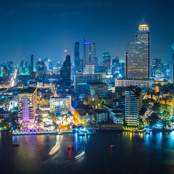 Thailand, Bangkok, City skyline with Chao Phraya river at night