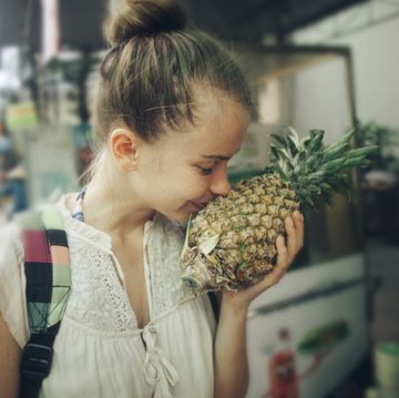a person holding a pineapple