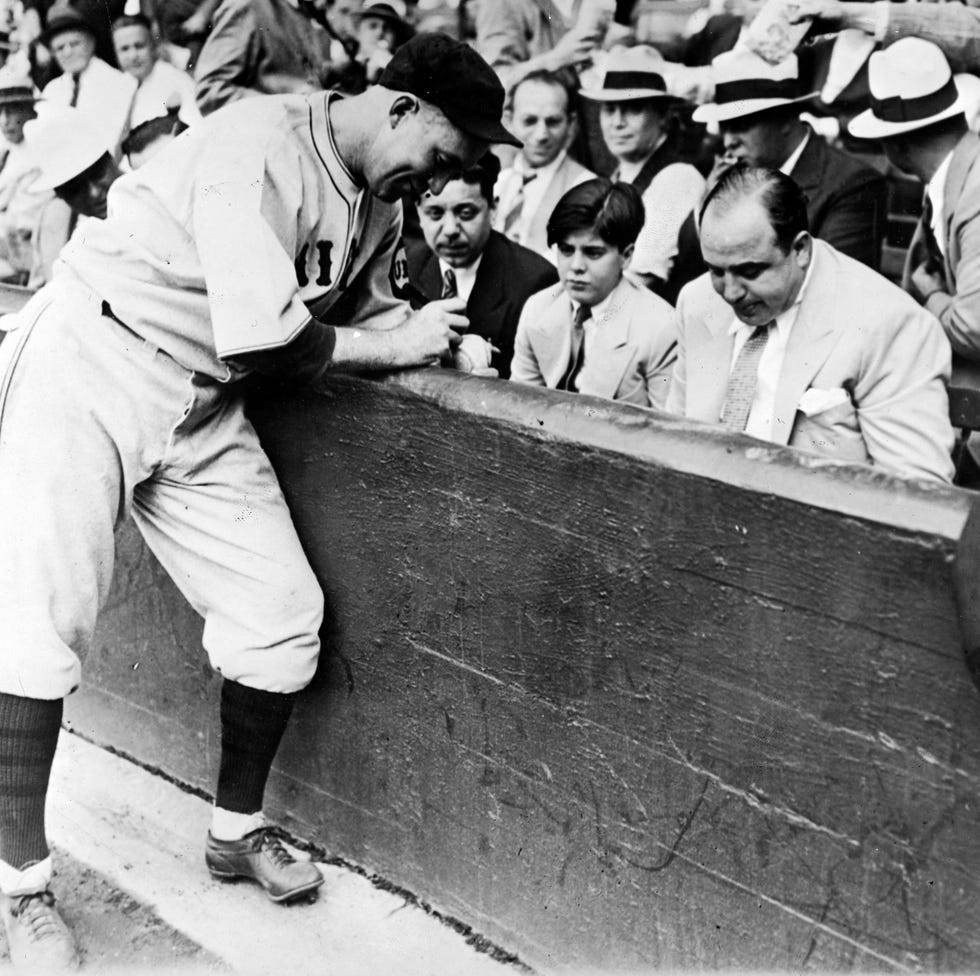 chicago, united states   september 10  gangster al capone and his son having baseball autographed by player gabby hartnett charles leo hartnett from capones front row seat at cominsky park stadium  photo by pix incthe life picture collection via getty images