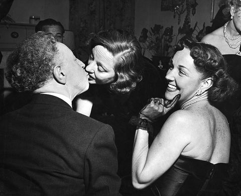 united states   november 01  artur rubinstein kissing actress tallulah bankhead while toni lainer looks on at a party thrown by gossip columnist hedda hopper for bankhead  photo by ed clarkthe life picture collection via getty images