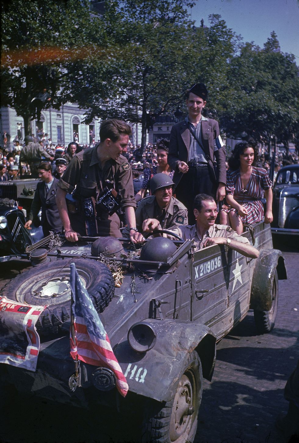 paris, france   august 26  car carrying journalists and photographers of yank magazine give a ride to french partisan and unidentified woman during parade held the day after the liberation of paris by allied troops  photo by frank scherscheltime  lif