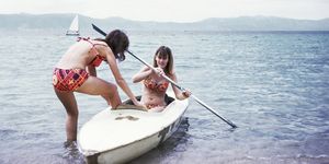 caucasian girls in kayak on lake
