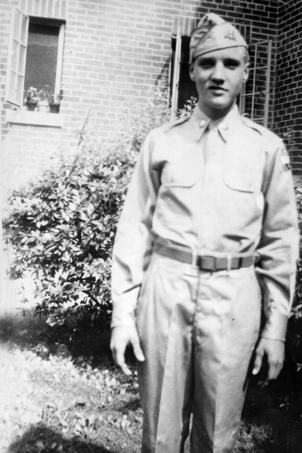 Elvis Presley poses for a portrait wearing his high school army ROTC uniform in 1955 in Memphis, TN.