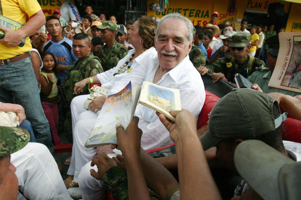 Colombian Nobel Prize for Literature 1982 Gabriel Garcia Marquez, sitting alongside his wife Mercedes Barcha, is asked by admirers to dedicate them books, before boarding the train to his hometown Aracataca 30 May, 2007 in Santa Marta, Colombia. Garcia Marquez didn't visit Aracataca in twenty years.
