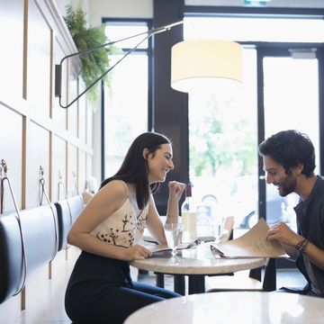 Couple looking at menus at cafe tablet