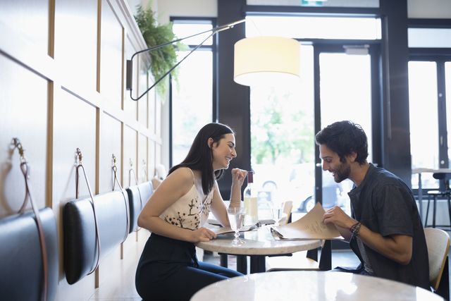 Couple looking at menus at cafe tablet