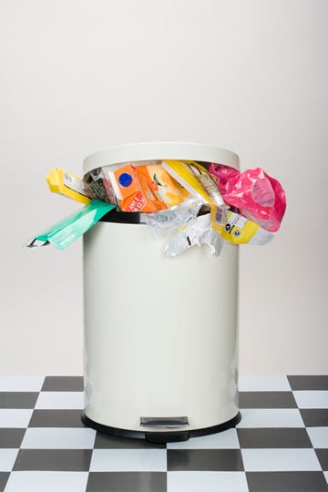 pedaloperated trash can filled with various types of waste