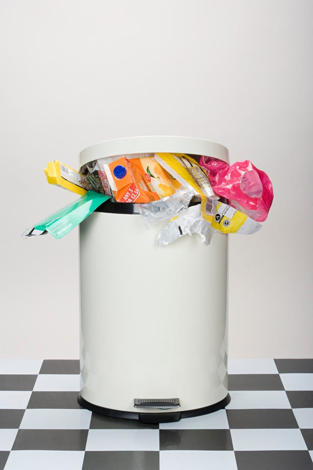 pedaloperated trash can filled with various types of waste