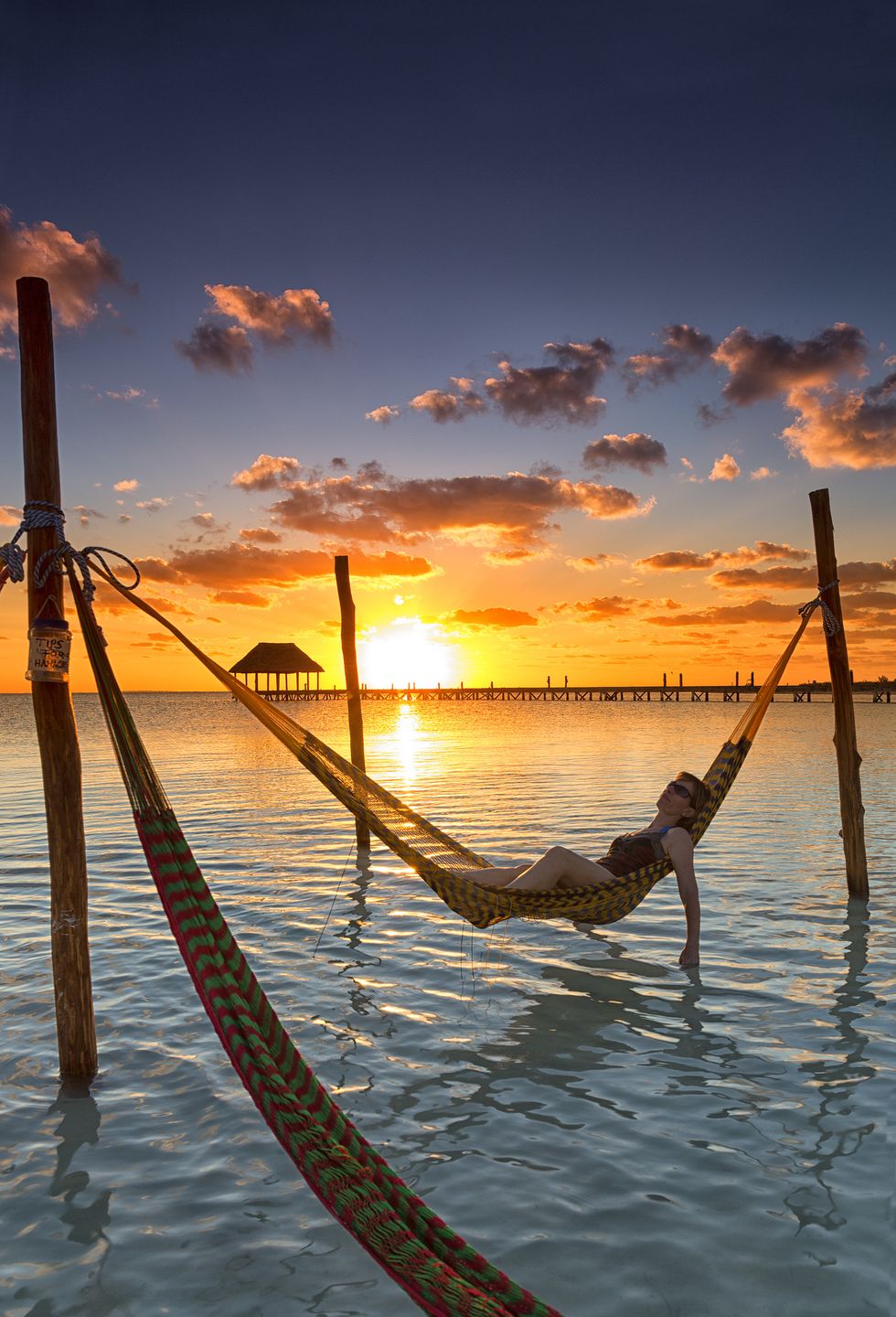 Woman in hammock at sunset, Holbox Island, Cancun, Yucatan, Mexico